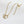 Gold necklace with interlocking rings on a white background