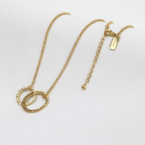 Gold necklace with interlocking rings on a white background