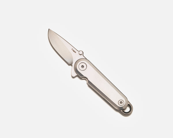 Folding knife with a metallic finish on a white background