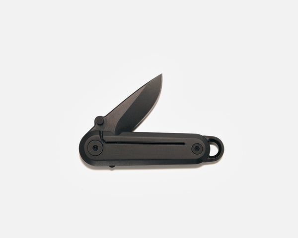 Black folding knife on a white background