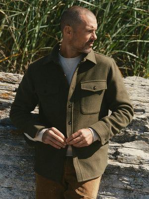 fit model buttoning up The Maritime Shirt Jacket in Heather Olive Wool