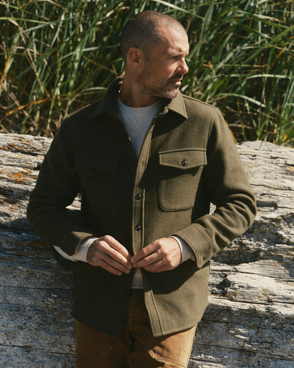 fit model buttoning up The Maritime Shirt Jacket in Heather Olive Wool