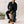 Man sitting on a log with a neutral background